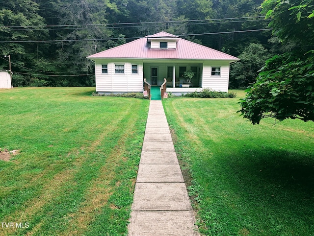 bungalow with covered porch and a front yard