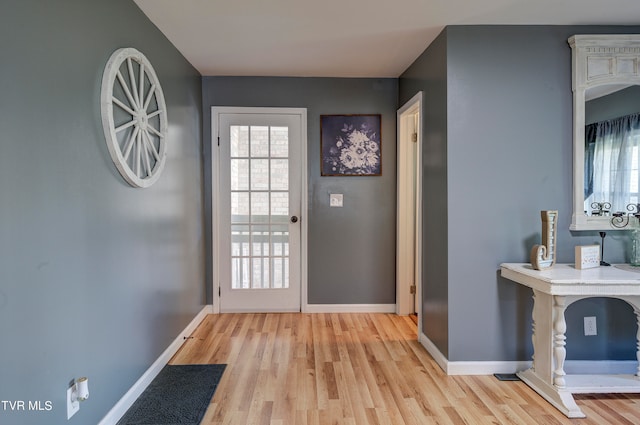 doorway with a healthy amount of sunlight and light hardwood / wood-style flooring