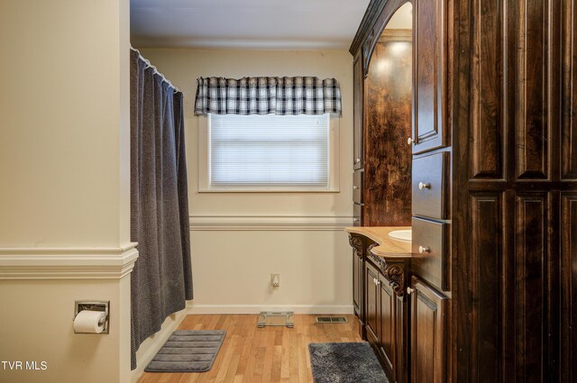 bathroom featuring vanity, curtained shower, and hardwood / wood-style floors