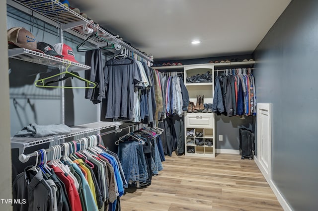 spacious closet with light hardwood / wood-style floors