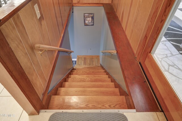 stairs featuring wooden walls