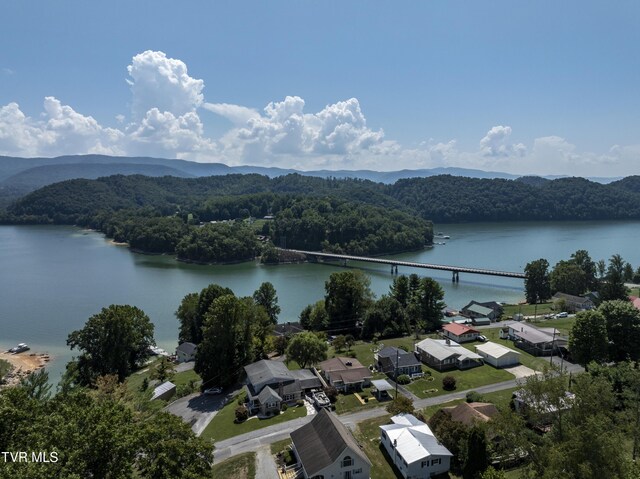 birds eye view of property with a water and mountain view