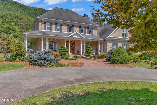 view of front of house featuring a mountain view and a porch