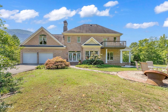 view of front of house with a front lawn, a patio area, and a balcony