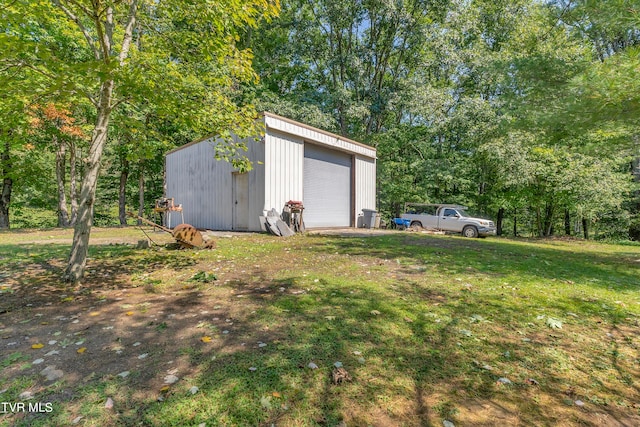 view of outbuilding with a garage and a yard