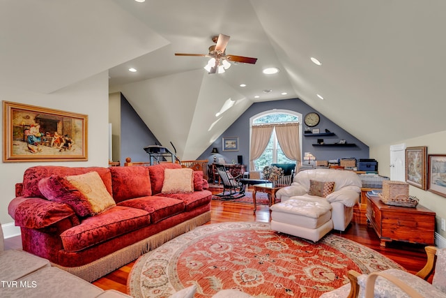 living room featuring hardwood / wood-style floors, ceiling fan, and vaulted ceiling