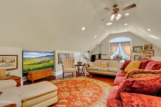 living room with hardwood / wood-style floors, ceiling fan, and vaulted ceiling