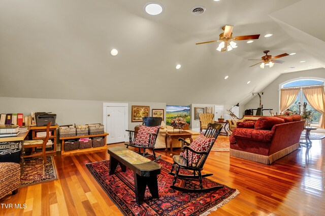 living room with lofted ceiling, hardwood / wood-style floors, and ceiling fan