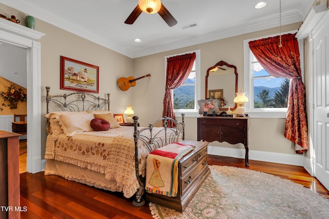 bedroom featuring crown molding, ceiling fan, and hardwood / wood-style flooring