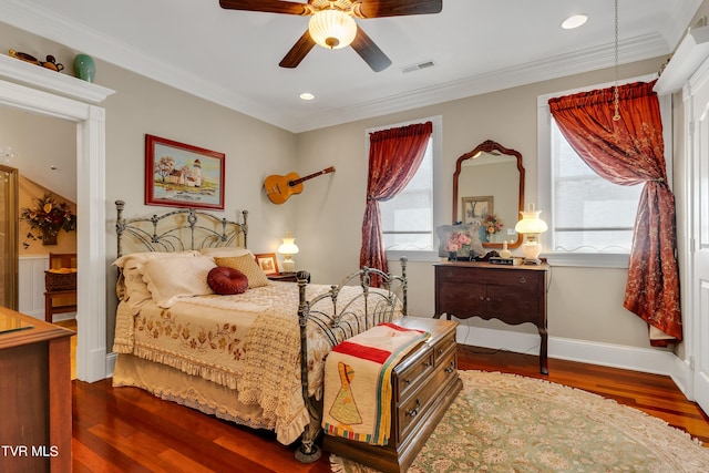 bedroom featuring dark wood-type flooring, ceiling fan, and ornamental molding