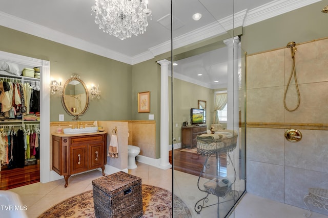 bathroom featuring tile patterned floors, tiled shower, vanity, and ornamental molding