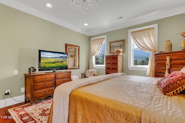 bedroom with ornamental molding, light hardwood / wood-style flooring, and a chandelier