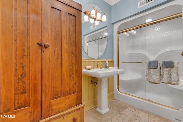 bathroom featuring a shower with shower door and tile patterned flooring