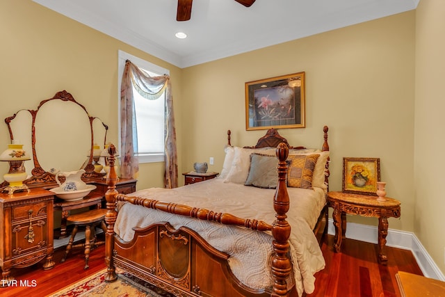 bedroom featuring dark wood-type flooring, ceiling fan, and ornamental molding