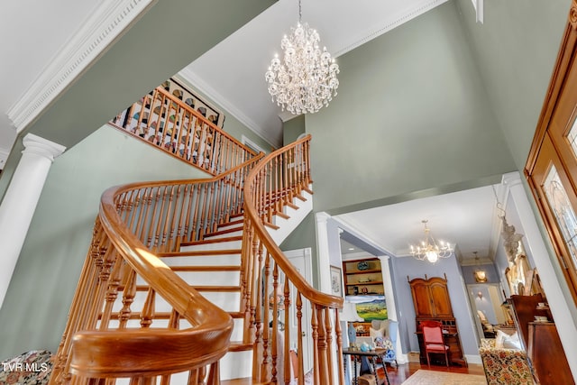 stairs featuring crown molding, a high ceiling, and an inviting chandelier