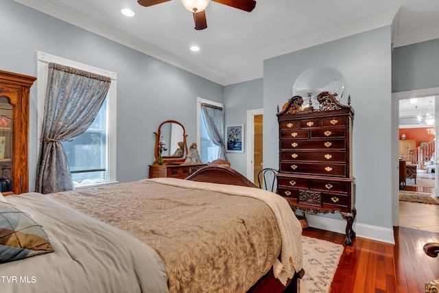 bedroom featuring ceiling fan, dark hardwood / wood-style floors, and ornamental molding