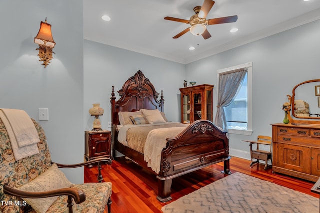 bedroom with ornamental molding, ceiling fan, and dark hardwood / wood-style floors