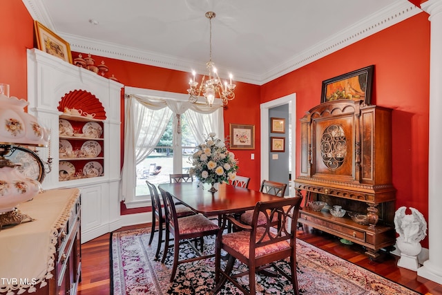 dining space with crown molding, dark hardwood / wood-style flooring, and a notable chandelier