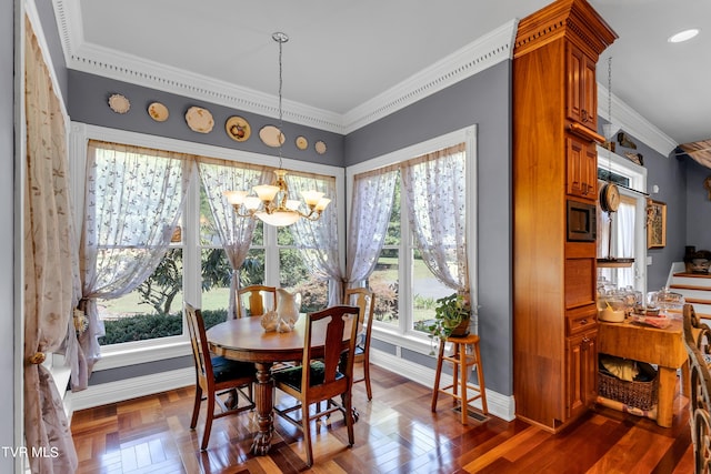 dining space featuring dark parquet flooring, an inviting chandelier, and ornamental molding