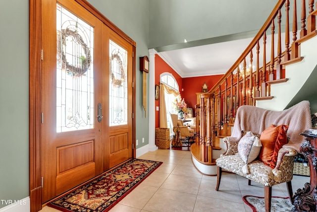 tiled entrance foyer featuring ornamental molding