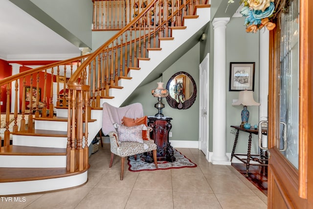 stairway with tile patterned flooring and ornate columns