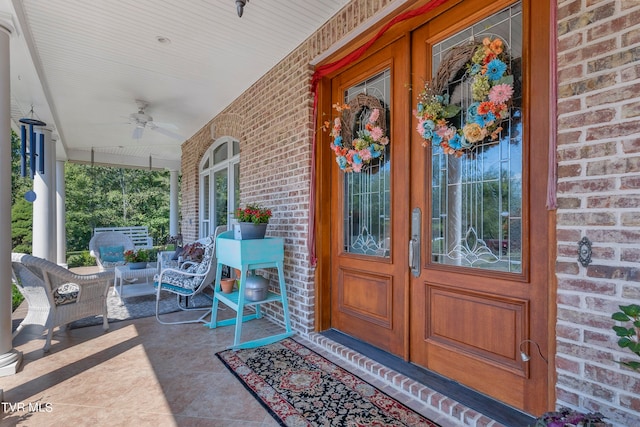 doorway to property with a porch and ceiling fan