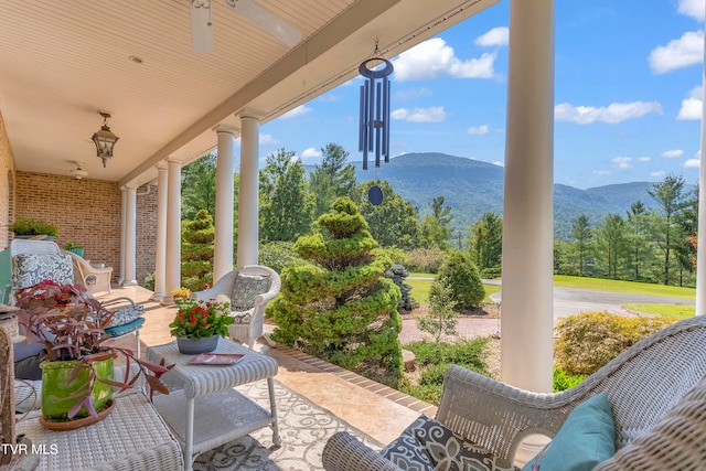 view of patio featuring a mountain view and covered porch