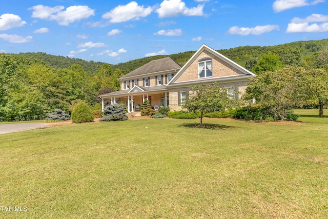 view of front of home featuring a front yard and covered porch