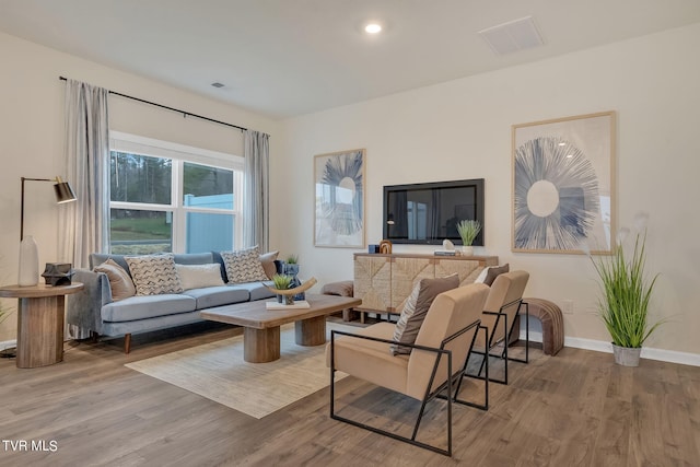 living area featuring recessed lighting, wood finished floors, visible vents, and baseboards