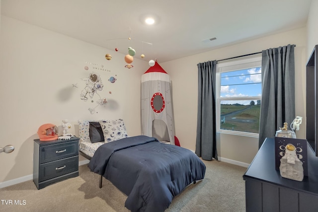 bedroom featuring light colored carpet and baseboards