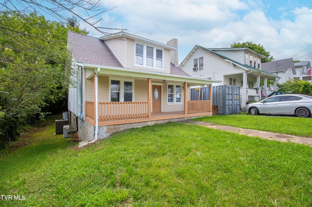 bungalow with covered porch, central AC, and a front yard