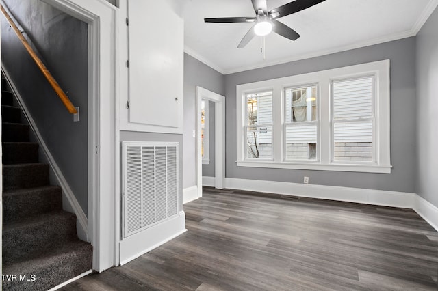 unfurnished living room featuring ceiling fan, dark hardwood / wood-style flooring, and ornamental molding