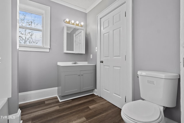 bathroom with vanity, toilet, ornamental molding, and wood-type flooring