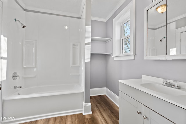 bathroom featuring hardwood / wood-style flooring, crown molding, shower / bathing tub combination, and vanity