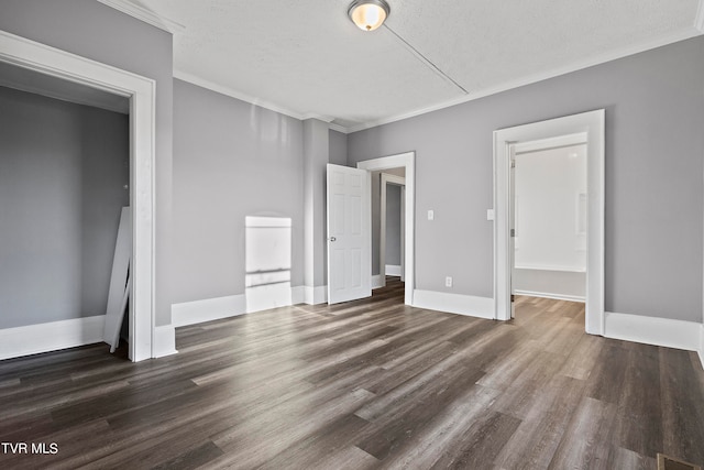 unfurnished bedroom featuring dark hardwood / wood-style flooring, crown molding, and a textured ceiling