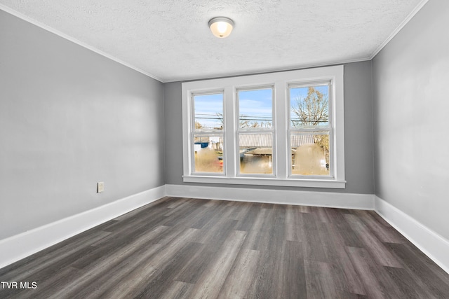 unfurnished room featuring a textured ceiling, dark wood-type flooring, and ornamental molding