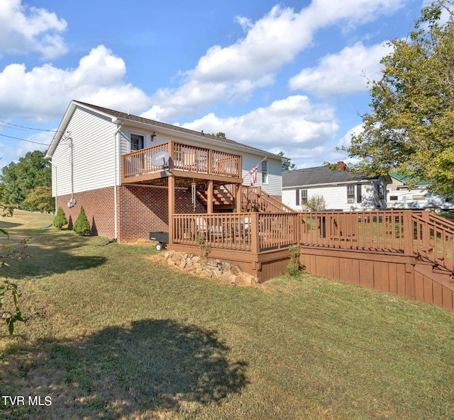 rear view of property featuring a yard and a deck