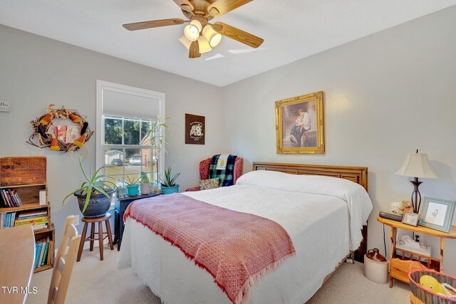 bedroom featuring light colored carpet and ceiling fan