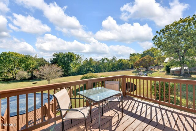 wooden terrace featuring a yard