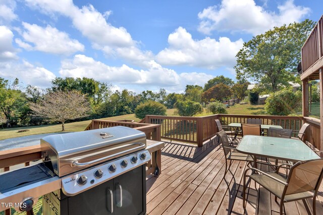 wooden deck with a grill