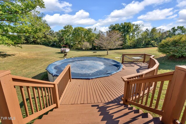 view of swimming pool featuring a yard and a deck