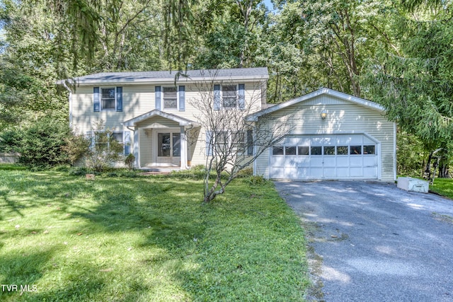 colonial inspired home featuring driveway and a front lawn