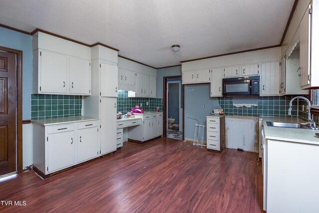 kitchen featuring backsplash, sink, white cabinets, and dark hardwood / wood-style floors