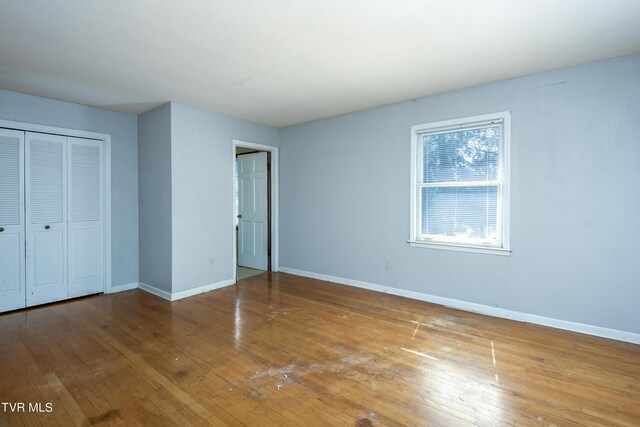 unfurnished bedroom with a closet and light hardwood / wood-style flooring