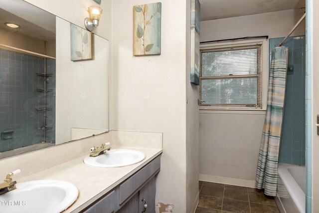 bathroom with vanity, shower / tub combo with curtain, and tile patterned floors