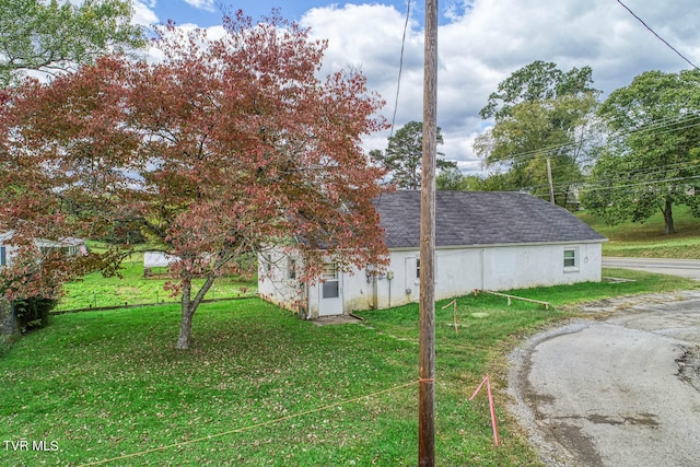 view of side of home featuring a yard