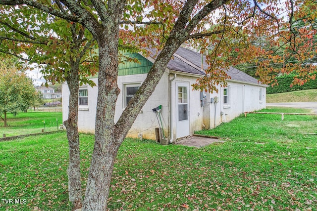 view of property exterior featuring a lawn