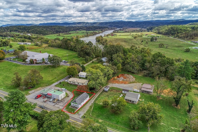 birds eye view of property featuring a water and mountain view and a rural view