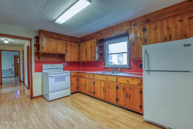 kitchen featuring open shelves, white appliances, light wood-type flooring, brown cabinets, and a sink