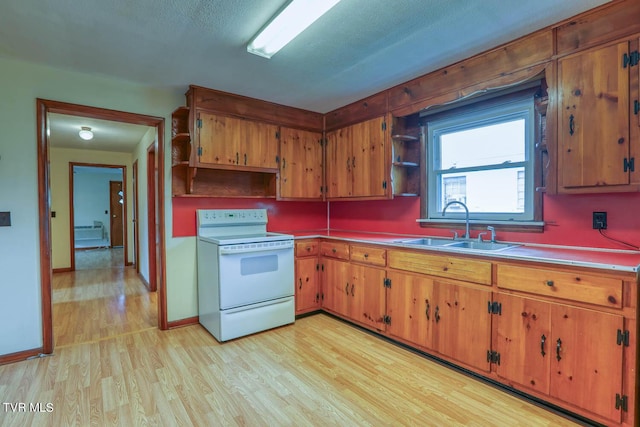 kitchen with brown cabinetry, open shelves, a sink, light wood finished floors, and white range with electric stovetop